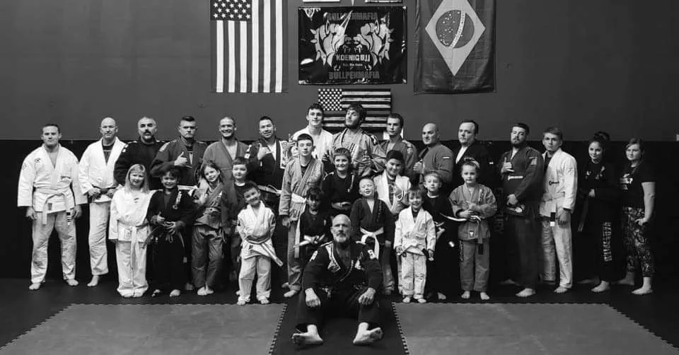 BJJ community group photo on the mats