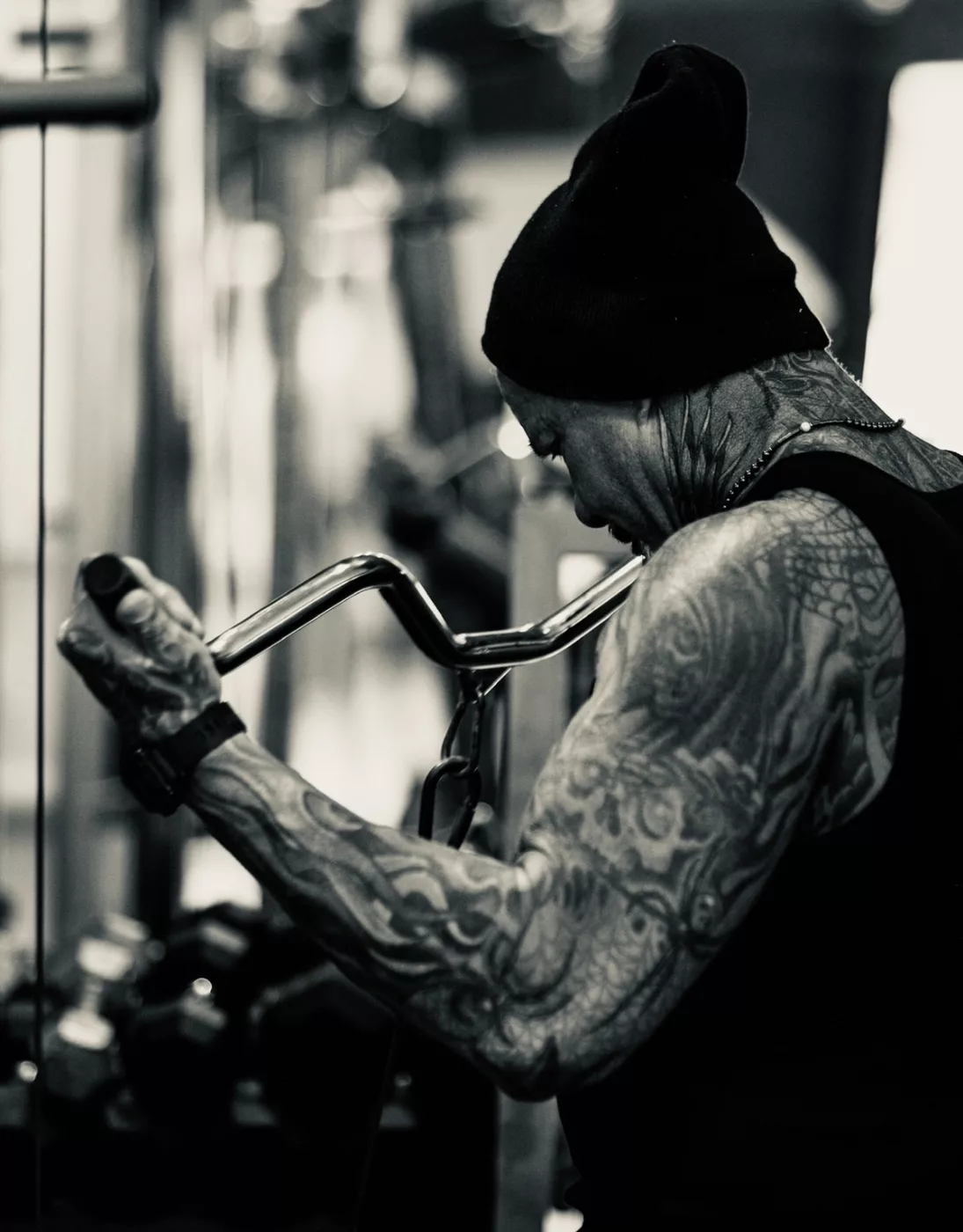 Rick Koenig mid-curl in a black and white gym photo, intense focus